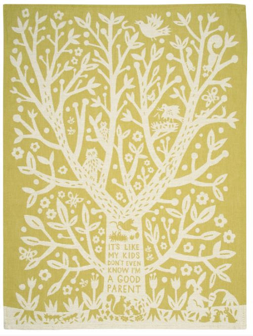 The **Kids Don't Even Know Dish Towel** by **Blue Dog Posters** features a decorative illustration of a large tree with various animals and plants among its branches against a yellow background, printed on high-quality cotton. The trunk bears a sign that humorously reads, "It's like my kids don't even know I'm a good parent." This charming tea towel is perfect for adding personality to your kitchen.