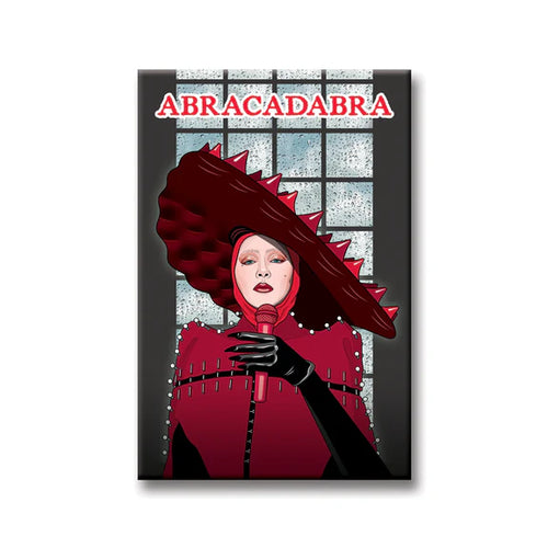 The Blue Dog Posters Lady Gaga Abracadabra Magnet features an illustration of Lady Gaga in bold red and black, holding a microphone before a window with "ABRACADABRA" in striking red letters above her head.