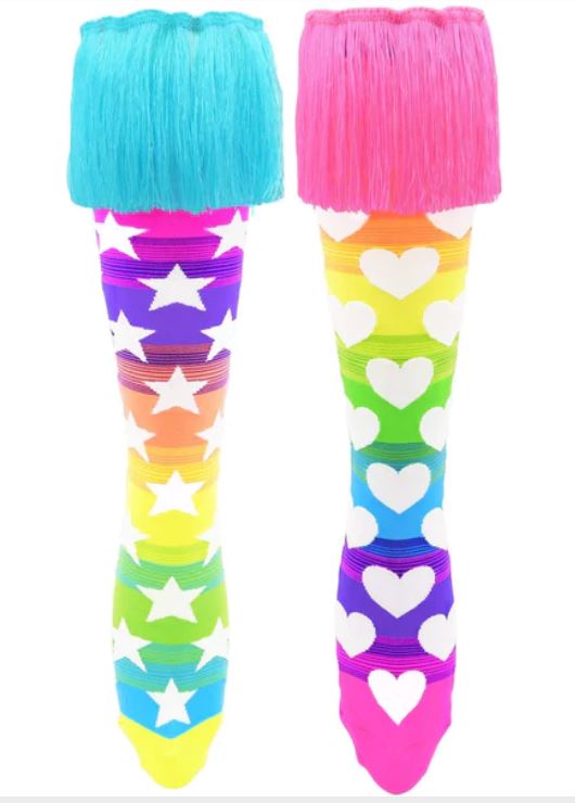 Displayed are the Madmia Lets Dance Socks from Blue Dog Posters. The left sock features blue fringe with a pattern of white stars on a rainbow background, while the right sock boasts pink fringe adorned with white hearts on a rainbow backdrop. These custom-made tassels add flair to every move!