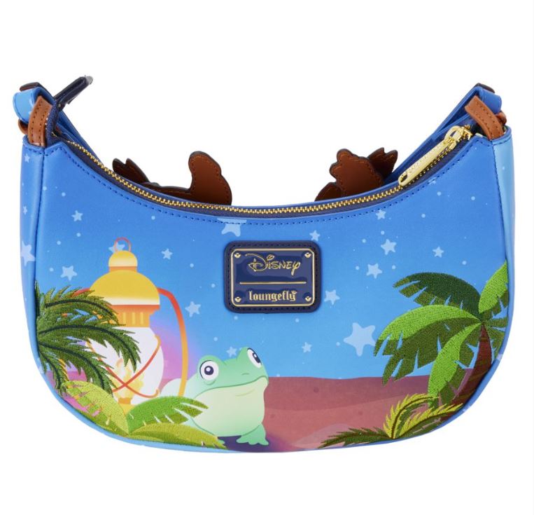 The Lilo & Stitch Camping Cuties Crossbody Bag by Blue Dog Posters showcases a charming design featuring a blue crossbody bag adorned with Disney and Loungefly logos. It depicts an adorable frog beside a glowing lantern, encircled by palm trees and a starry night sky. The bag is accented with brown details and features a zip closure for secure storage.