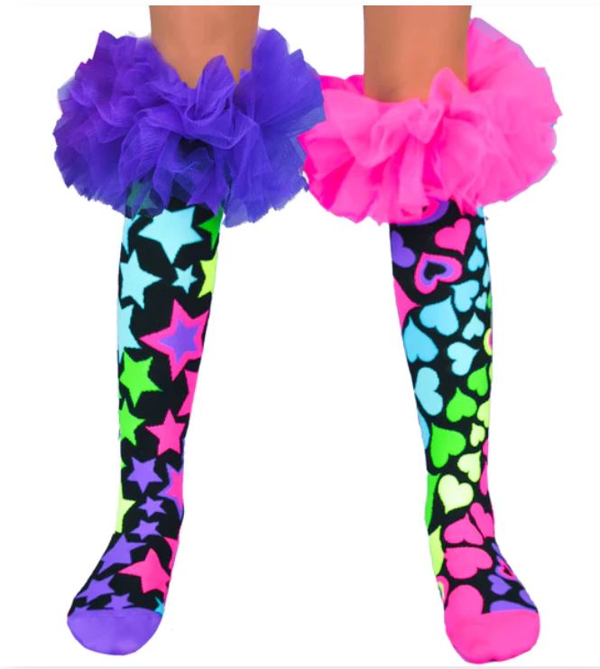 The Madmia Magic Frills Socks by Blue Dog Posters boast vibrant star and heart patterns with fluffy tulle ruffles in purple and pink. These knee-high socks perfectly capture the essence of playful, colorful silly socks!