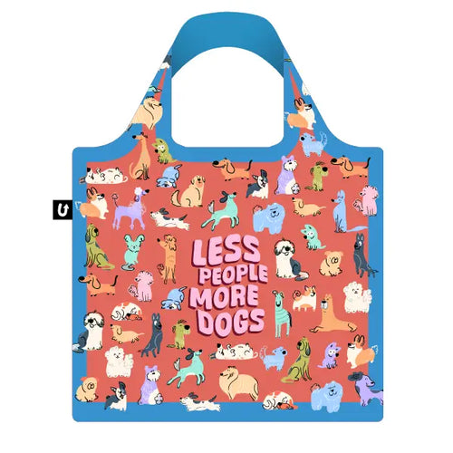 The More Dogs Foldable Tote Bag by Blue Dog Posters is a reusable, foldable tote with blue handles and border, colorful cartoon dogs on red, made from recycled PET bags and bold pink "LESS PEOPLE MORE DOGS" text.