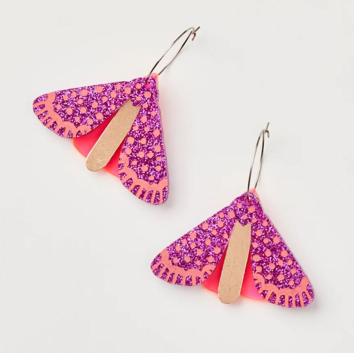 Blue Dog Posters' Moth Earrings - Magenta Neon feature vibrant magenta neon wings adorned with intricate purple glitter patterns, suspended from thin surgical steel hooks.