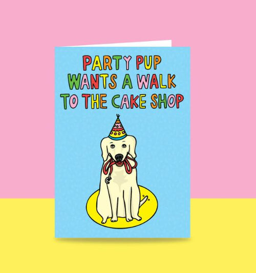 The Party Pup Greeting Card by Blue Dog Posters features an adorable illustration of a dog wearing a party hat, with the cheerful text, "Party Pup Wants a Walk to the Cake Shop." Set against a pastel blue background with multicolored text, this vibrant card is perfect for any celebration. Proudly designed in Australia.