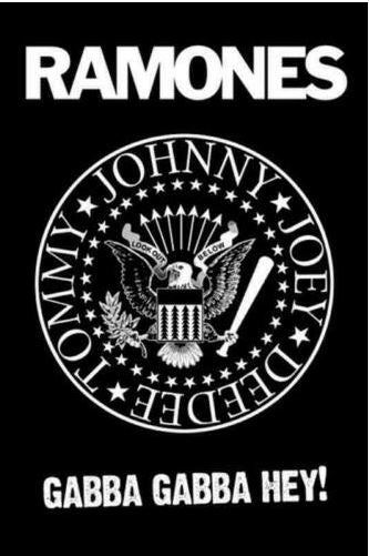 The RAMONES GABBA GABBA HEY by MUS 091 features a striking black and white graphic with the iconic Ramones logo. This rock poster displays a circular emblem adorned with an eagle and the names "Johnny, Joey, Dee Dee, Tommy" around it, accompanied by the text "Gabba Gabba Hey!" below. Ideal for any music collection or as large regular posters on your wall.