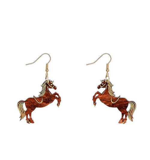Blue Dog Posters Rodeo Horse Earrings feature gold hooks and prancing horse charms crafted from lasercut tortoiseshell acrylic. The horses are brown with gold accents outlining their manes, tails, and saddle details. Both earrings are identical, showcasing the horse in a rearing position with lifted front legs.