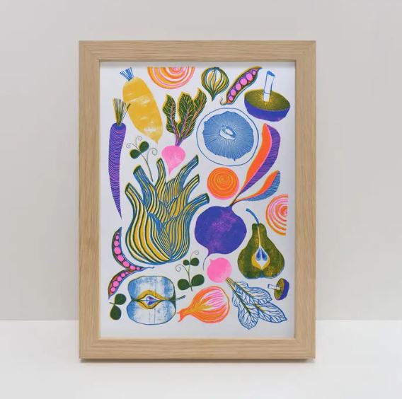 The Roots Fruits & Shoots A4 Riso Print by Printer Johnson, from Blue Dog Posters, showcases abstract illustrations of vegetables and fruits like carrots, onions, pears, and mushrooms in vibrant blues, yellows, pinks, and greens on a white background.