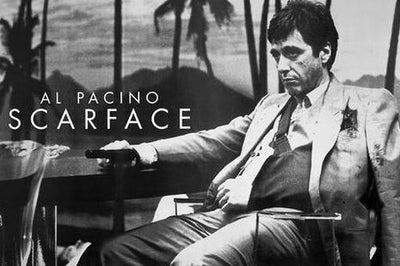 The Scarface - Classic Sling by MTV 399 features Al Pacino as Tony Montana, stern and suit-clad at a table with palm trees and mountains behind. Printed on premium gloss paper, it’s a must-have cult movie poster for any collection.