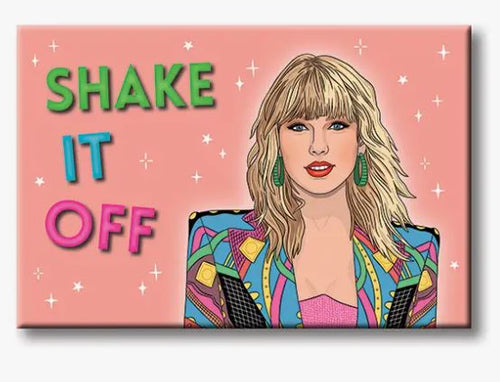 A vibrant illustrated portrait of a woman with blonde hair and green earrings set against a pink backdrop. She is dressed in a colorful, patterned blazer. To the left, the phrase "SHAKE IT OFF" is artfully displayed in green, blue, and pink letters that look like fridge magnets. The background is adorned with small sparkles. Presenting the Taylor Swift Shake it Off Magnet by Blue Dog Posters.