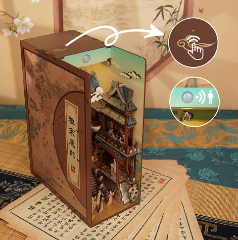The Blue Dog Posters Song Dynasty Large Book Nook Tonecheer is a decorative lamp shaped like a book, featuring an intricate Song Dynasty miniature, touch and motion sensor icons, all resting on Chinese calligraphy-patterned fabric.