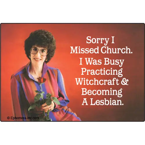 A woman with curly dark hair, glasses, and a colorful blouse holds roses and smiles before a red backdrop. White text reads: "Sorry I missed church. I was busy practicing witchcraft & becoming a lesbian." Blue Dog Posters' Sorry I Missed Church Magnet.