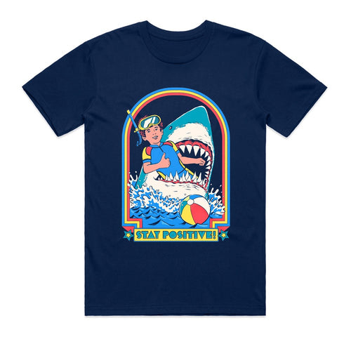 The Blue Dog Posters Stay Positive T-Shirt Navy SML features a colorful illustration of a snorkeling child with a shark, beach ball, waves, and “Stay Positive!”—perfect for everyday wear.
