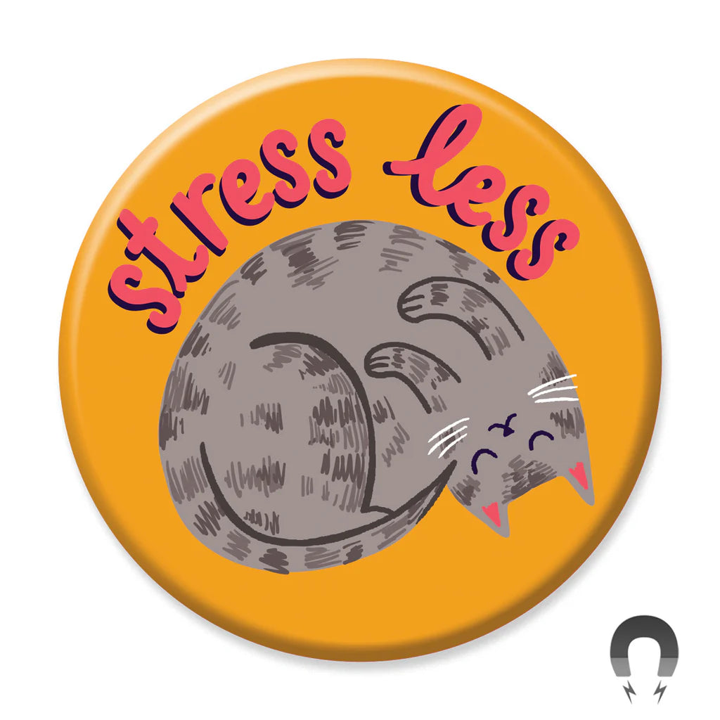 The Stress Less Cat Magnet by Blue Dog Posters is a round orange magnet with a gray sleeping cat and the words "stress less" in fun red and pink letters above it.