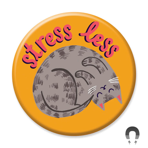 The Stress Less Cat Magnet by Blue Dog Posters is a round orange magnet with a gray sleeping cat and the words "stress less" in fun red and pink letters above it.