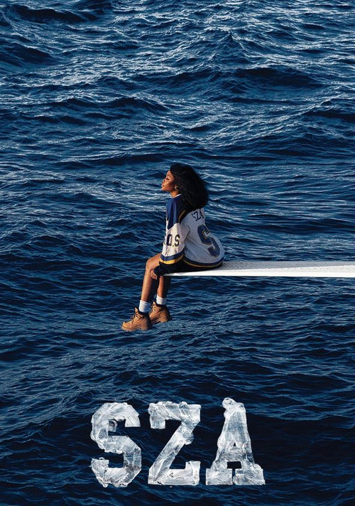 A woman in a sports jersey and boots sits on a diving board that stretches over a vast, choppy ocean. Below her, the text "SZA" is displayed in large, block letters with a textured, watery appearance. This R&B poster from MUS 081 is perfect for your music collection and printed on premium 150gsm gloss paper.