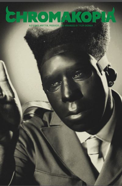 A stylized black and white image of a person with a high-top fade hairstyle, dark glossy face mask, and suit and tie features the text "CHROMAKOPIA" in green above. Product: Tyler the Creator Chromakopia by MUS 222.
