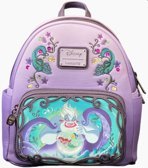 A lavender Disney Villains - Ursula Scene Mini Backpack by Blue Dog Posters featuring embroidered designs of sea creatures and floral patterns. The front zipper pocket showcases a colorful illustration of Ursula from The Little Mermaid, holding Ariel in her tentacles against a watery background, making it the perfect addition to any Disney Villains collection.