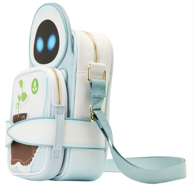 The Wall-E Date Night Crossbuddy Backpack from Blue Dog Posters is a light blue and white Loungefly bag crafted to resemble Eve, a character from the movie. This Disney-Pixar merchandise showcases blue LED-like eyes on a circular flap, a plant graphic on the front pocket, two zippered compartments, and an adjustable strap made of vegan leather.