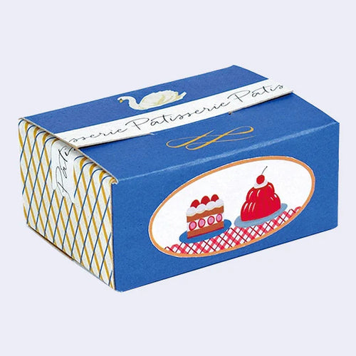 The Western Sweets Mini Sticker Box Meat by Blue Dog Posters is a small blue box with a white swan label on top, a diamond side pattern, and two dessert drawings on a checkered front.
