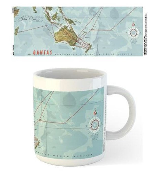A white ceramic mug from Blue Dog Posters, featuring a vintage world map design with red flight route lines and compass roses. The text "Qantas," a notable airline, is highlighted. This dishwasher-safe Qantas - 1965 Route Map Mug is shown from the side and also laid flat to showcase the map in detail.