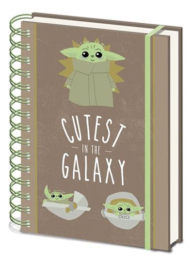 A Mandalorian Cutest A5 Spiral Note Book by Blue Dog Posters featuring cartoon illustrations of Baby Yoda in three different poses. The cover has a caption that reads "CUTEST IN THE GALAXY." The background is a brownish color with green accents, making it an ideal choice for stationery gifts.