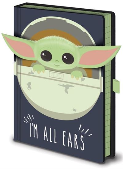 The Blue Dog Posters Mandalorian All Ears Premium Note Book features an illustration of a small, green, big-eared character peeking over a circular frame. The high-quality hard cover is dark with the phrase "I'M ALL EARS" written at the bottom in a playful white font. Perfect for stationery gifts, it includes a green strap attached to the side.