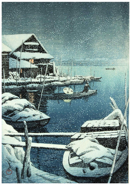 A serene winter scene depicts snow-covered wooden houses beside a calm, blue lake. Snow falls gently as several boats, also blanketed in snow, float near a dock. A person rows a boat with a lantern, casting a soft glow on the tranquil water—a perfect addition to your collection of A3 475's Snow In Mukojima.