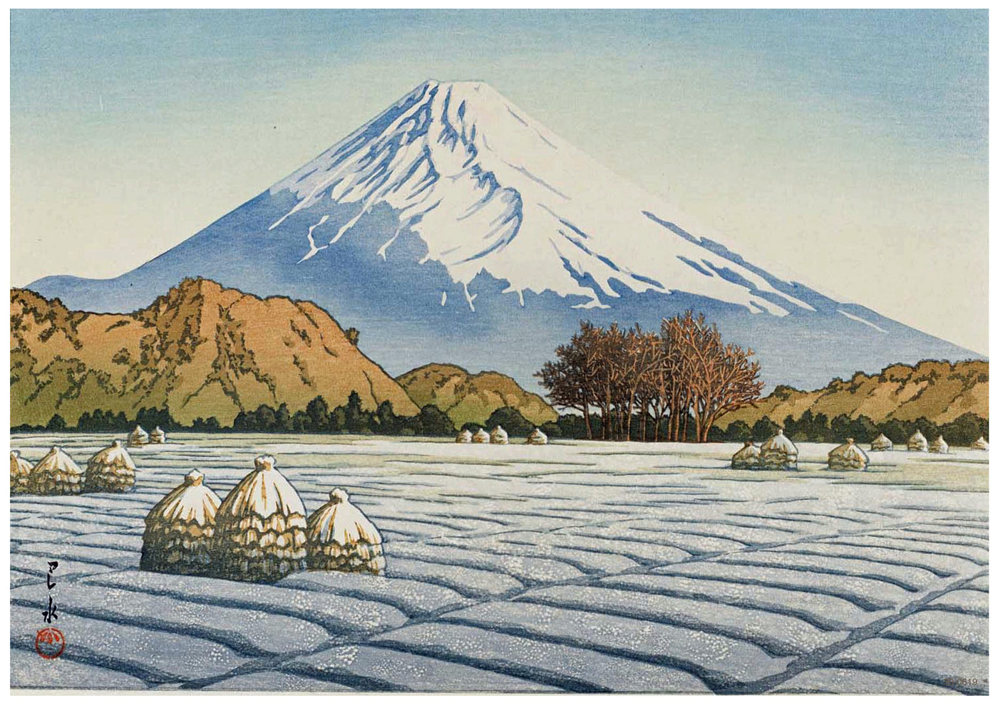 A serene winter landscape features Mount Fuji in the background, its peak covered in snow. In the foreground, snow-covered straw bundles dot a frozen field. Leafless trees stand to the right, with rolling hills separating the mountain from the fields. Perfect as an A3 492 Frosty Morning Japanese Art Poster on high quality 250gsm Satin Paper.