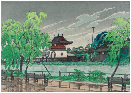 A traditional Japanese landscape painting is beautifully captured in this A3 493 Pond in Rain poster, depicting a serene scene with a temple and torii gate near a pond, surrounded by lush greenery. The overcast sky and people holding umbrellas along the path add a peaceful touch to this Japanese art poster on 250gsm satin paper.