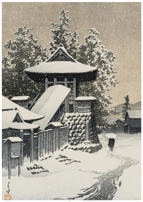 A traditional Japanese gate and surrounding buildings are covered in snow. The path leading to the gate is also blanketed with snow. Tall trees stand in the background, and the sky is filled with falling snowflakes, creating a serene winter scene, perfect for an A3 520 Kawase Bell Tower at Mt Koya printed on high quality 250gsm Satin Paper.