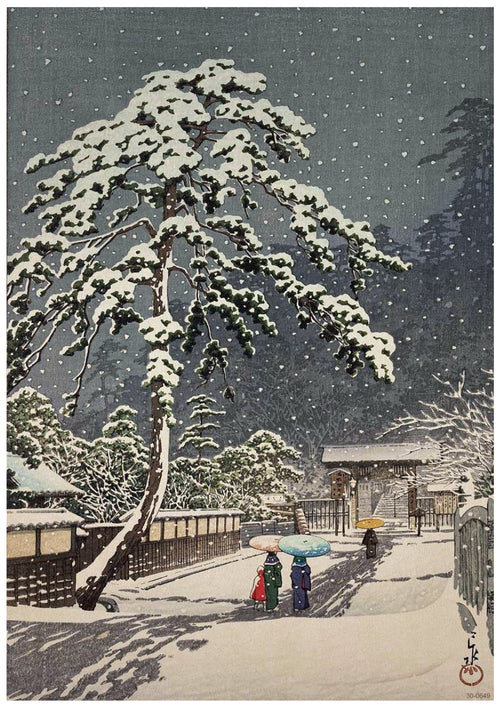 A serene winter scene features three people with colorful umbrellas walking along a snow-covered path. The path is bordered by a fence and traditional Japanese buildings. Snow covers the branches of a large, elegant pine tree, and snowflakes gently fall from the sky. Perfect as an A3 521 Kawase Ikegami Honmonji printed on 250gsm Satin Paper.