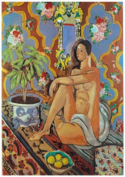 The Decorative Figure Ornamental Matisse poster from Blue Dog Posters portrays a nude woman seated on an elaborately patterned carpet, with her body partially covered by a draped cloth. A potted plant is placed to her left, and a bowl of lemons is prominently displayed in the foreground. The vibrant background showcases floral and geometric designs. This stunning artwork is available as A3 posters printed on high-quality 250gsm satin paper.