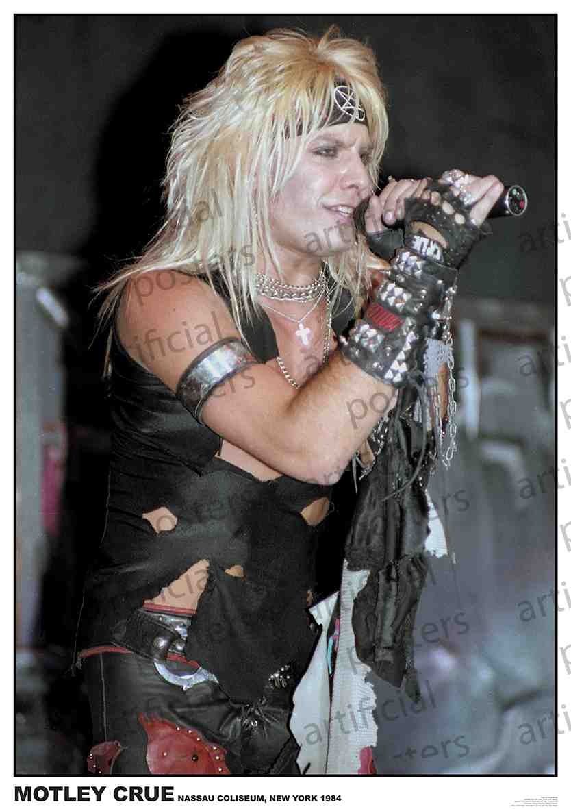 A rock singer with long blonde hair and a headband performs passionately on stage, wearing a torn black outfit and fingerless gloves. Microphone in hand, he is captured mid-song, showcasing the energetic atmosphere of the concert. MUS 114 product name reads "Motley Crue Vince Neil 1984: Nassau Coliseum, New York 1984.