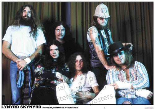 A photo of six members of the rock band Lynyrd Skynyrd, taken in October 1975 at De Doelen, Rotterdam. The band members are posing casually with a curtain as the background. Some are standing while others are sitting, dressed in 70s rock attire—perfect for your music collection or as a stunning Lynyrd Skynyrd Holland 1975 by MUS 127 on premium 150gsm gloss paper.