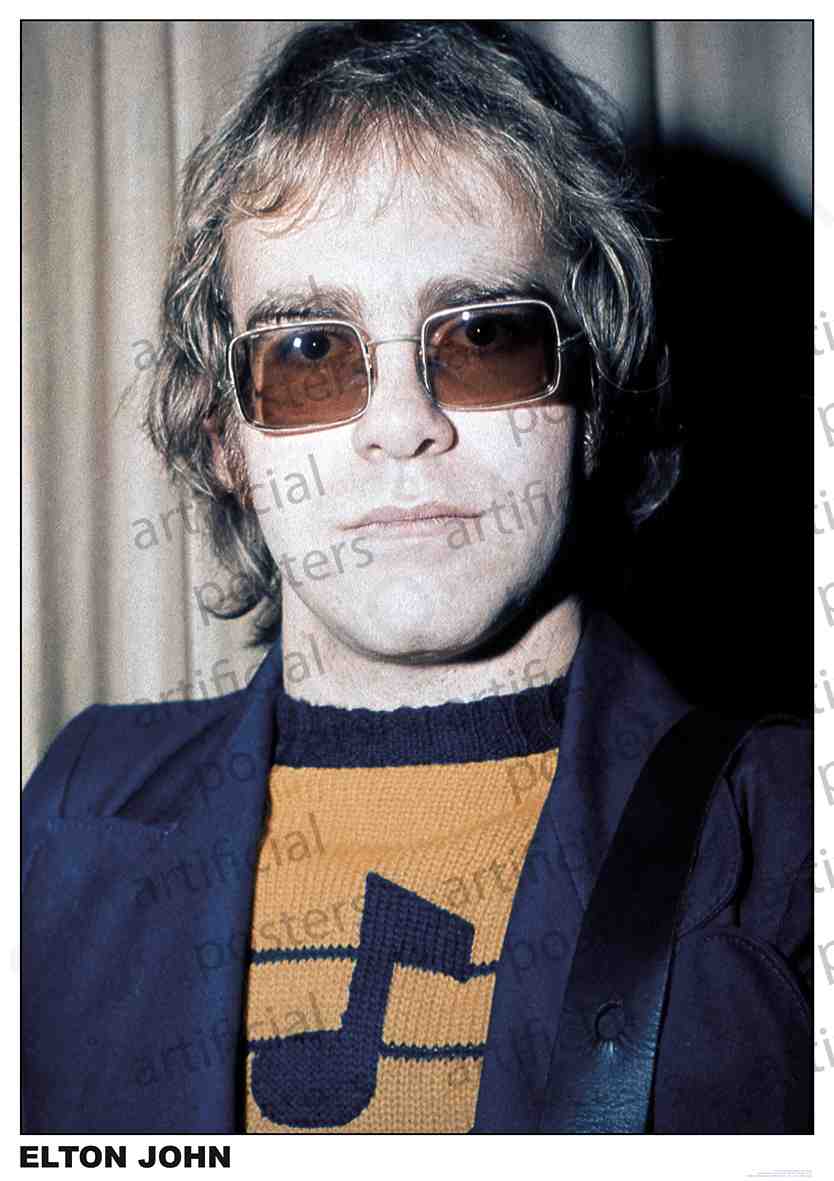 A person with medium-length hair and glasses is wearing a sweater with a music note design and a dark blazer. The background has a curtain. The text at the bottom says "ELTON JOHN." This high-quality printing on premium gloss paper makes for the perfect addition to any Elton John London set by MUS 102.