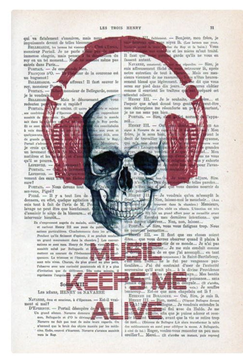 An illustrated design featuring a skull wearing red headphones superimposed on a page from an antique French book. Below the skull, the text "Music Keeps Me Alive" is written in bold capital letters. This unique print combines vintage allure with modern flair. The product is called "Antique Book print 29x19cm Skull Music 1" by ABP.