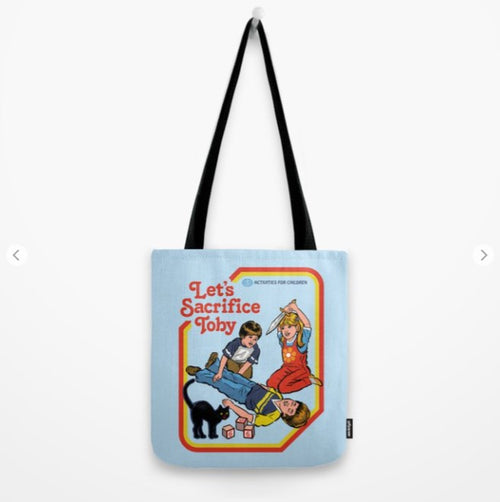 The Tote Bag 40x40cm Lets Sacrifice Toby by Blue Dog Posters, made of quality blended fabric, features a retro-style cartoon illustration of three children. One child lies down while the other two stand over him, appearing to perform a ritual. The text reads "Let's Sacrifice Toby," with smaller text saying "A Children's Book." Perfect for any giftware collection.