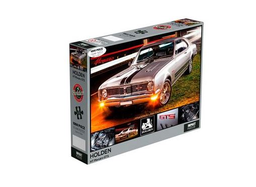 A jigsaw puzzle box featuring an image of a vintage silver Holden muscle car with headlights on, parked on a road. The box displays "1000 PIECES" prominently and includes smaller images of car-related details. Officially licensed and part of the Giftware Collection, it reads "Holden - 1970 HT Monaro 1000pc Puzzle" by Blue Dog Posters.