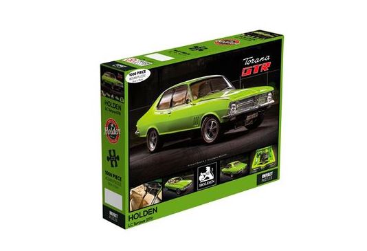 The image shows a 1000-piece jigsaw puzzle box featuring a classic lime green Holden Torana GTR car. As part of the officially licenced Giftware Collection, the box showcases green and black colors with the car image on the front. The Blue Dog Posters product, "Holden - 1971 LC Torana 1000pc Puzzle," brand and specifications are displayed along the edges.