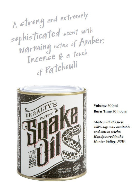 Image of Blue Dog Posters' Dr Salty Snake Oil Soy Wax Candle labeled "Dr Salty’s Patent Snake Oil." The vintage-inspired design features a coiled snake. Text above describes the soy wax candle's amber, incense, and patchouli scent. Additional details: 500ml volume, 70-hour burn time, hand-poured in Hunter Valley, NSW.