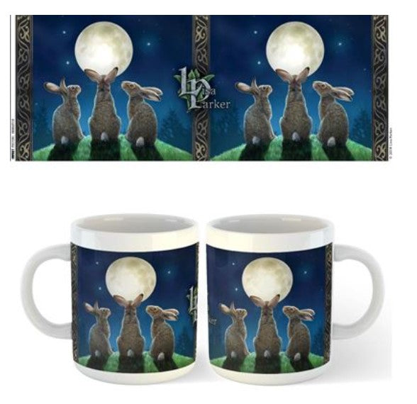 Two Blue Dog Posters Lisa Parker Mug - Moon Shadows featuring three rabbits on grass, gazing at a full moon in a starry night sky. The quality ceramic finish showcases Lisa Parker's artwork, framed with decorative borders. Displayed side by side, they present the same enchanting moonlit scene.