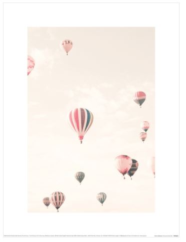 A collection of vibrant hot air balloons, featuring an array of colors and patterns, gently floats through a pale, cloud-dappled sky. The scene exudes a soft, pastel quality, creating a dreamy and serene atmosphere. This exquisite art print by Caroline Mint captures the depth of balloons both near and far as part of our small decor series from Blue Dog Posters.