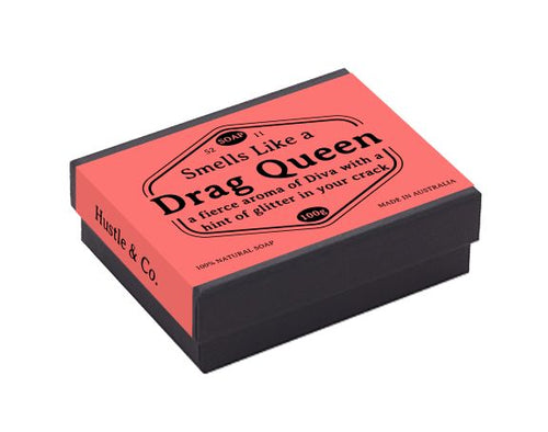 A rectangular black and pink soap box labeled "Hustle and Co Soap - Drag Queen" with additional text: "a fierce aroma of Diva with a hint of glitter in your crack," "Blue Dog Posters," "100% Natural Soap for Sensitive Skin," and "Made in Australia.