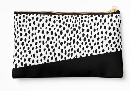 The Dalmation Spots Zipper Pouch Lge from Blue Dog Posters is a rectangular, artist-designed large zipper pouch with a white background featuring black Dalmatian spots on the top portion and a solid black section on the bottom. Crafted from durable polyester canvas, it is accentuated by a gold-colored zipper.