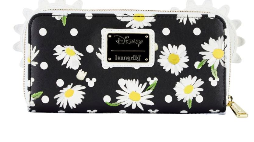 The Disney Minnie Mouse Daisies Zip Purse by Blue Dog Posters is a black wallet adorned with white polka dots and a delightful pattern of white daisies with yellow centers and green leaves. A gold-colored tag in the center reads "Disney Loungefly," complemented by a matching gold zipper pull. The edges are finished with a charming white scalloped design, making it an enchanting Disney-licensed accessory.