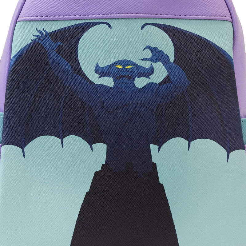 A stylized image of a menacing gargoyle with glowing yellow eyes and large wings, standing atop a castle, captures the mythical magic of the Disney Villains Colour Block Mini Backpack by Blue Dog Posters. The background's shades of purple and blue intensify the eerie atmosphere.