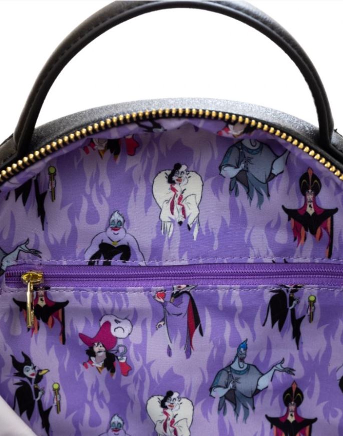 The interior of the Disney Villains Purple Flame Backpack by Blue Dog Posters showcases a lining adorned with a purple flame pattern and various villain characters from animated movies. There is a purple zippered pocket in the center, and the edge of the black backpack with a gold zipper is visible at the top.