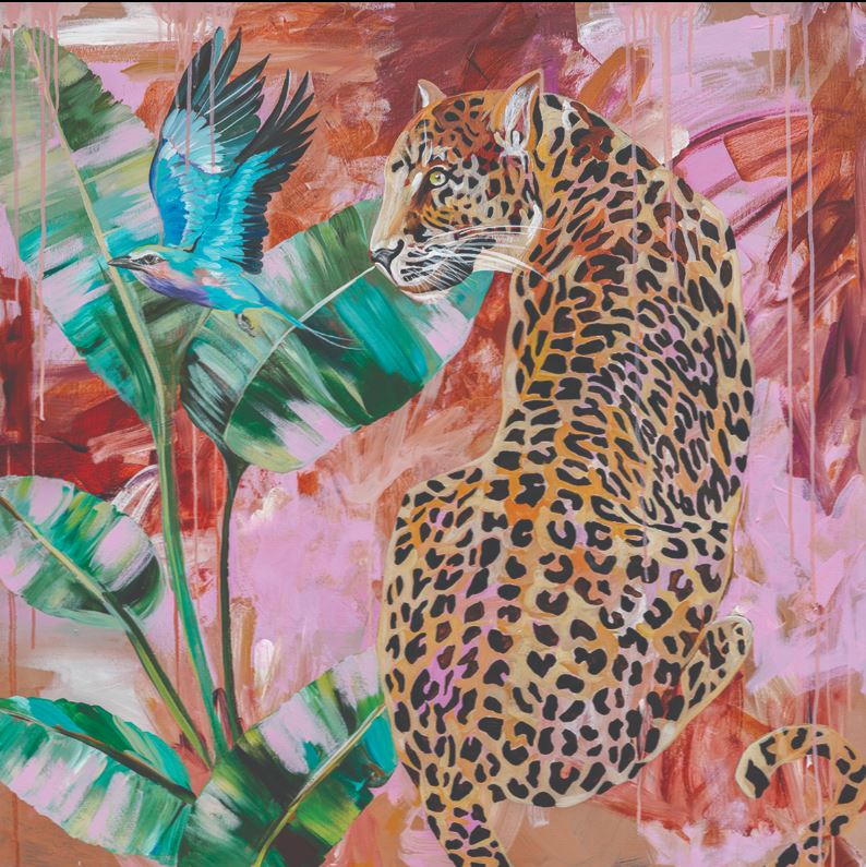 The vibrant art print titled "Distant longing" by Heylie Morris, from MEZ 513, features a leopard sitting calmly among tropical greenery with large leaves. A small blue hummingbird hovers nearby. The background is a mix of warm and cool hues, creating a dynamic, abstract effect that showcases the premium quality of her work.