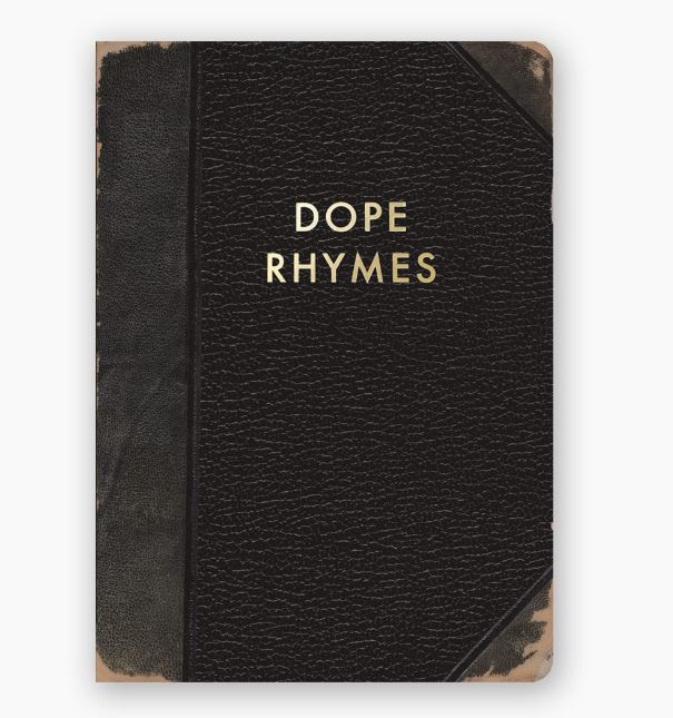 A black leather-bound Dope Rhymes Journal by Blue Dog Posters, showcasing worn edges and "DOPE RHYMES" gold foil stamped on the cover. This handy journal features dotted pages, ideal for organizing your thoughts and unleashing your creativity.