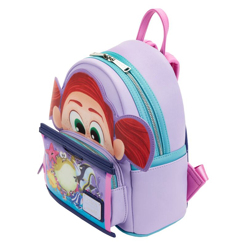The Finding Nemo Darla Mini Backpack by Blue Dog Posters is a pastel purple children's backpack that showcases a cartoon character's face with red hair on the front. This backpack, inspired by *Finding Nemo*, features pink and blue zippers, a small front pocket with an aquatic theme reminiscent of Darla's Fish Tank, and pink shoulder straps.